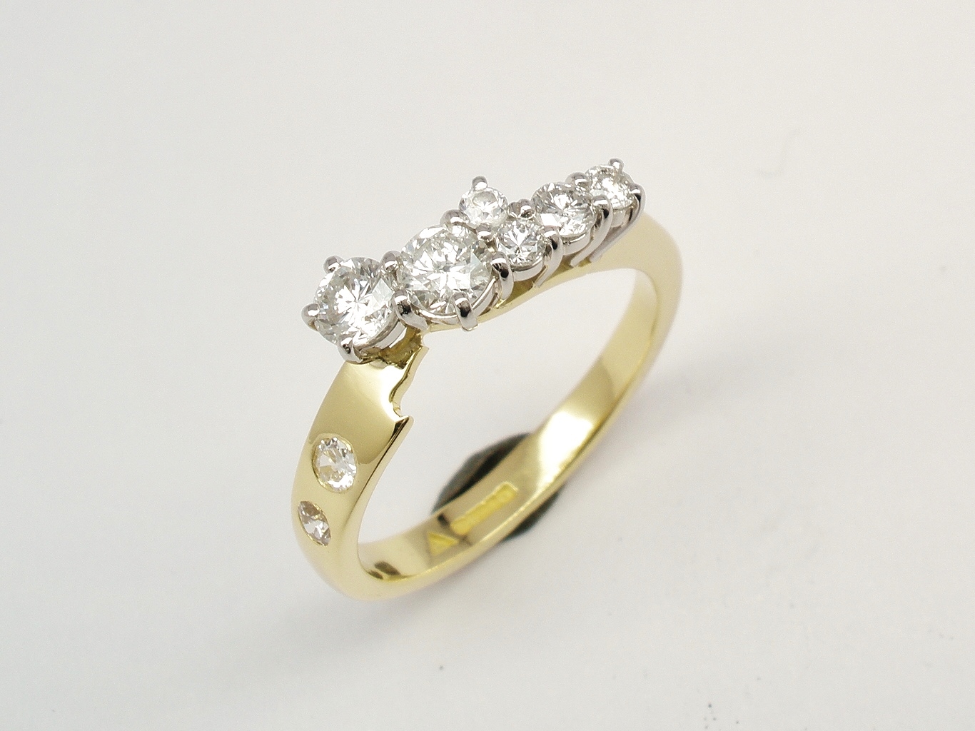 An 8 stone diamond ring mounted in 18ct. yellow gold and platinum shaped to fit with a single stone diamond ring.