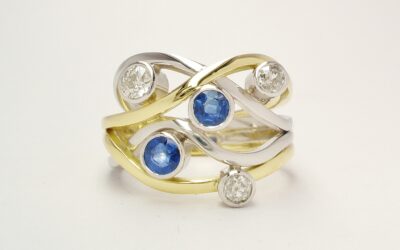 A 5 stone round sapphire and brilliant cut diamond 4 banded ring mounted in 18ct yellow gold and platinum.