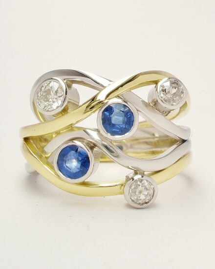 A 5 stone round sapphire and brilliant cut diamond 4 banded ring mounted in 18ct yellow gold and platinum.