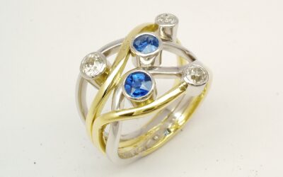 A 5 stone round sapphire and brilliant cut diamond 4 banded ring mounted in 18ct yellow gold and platinum.