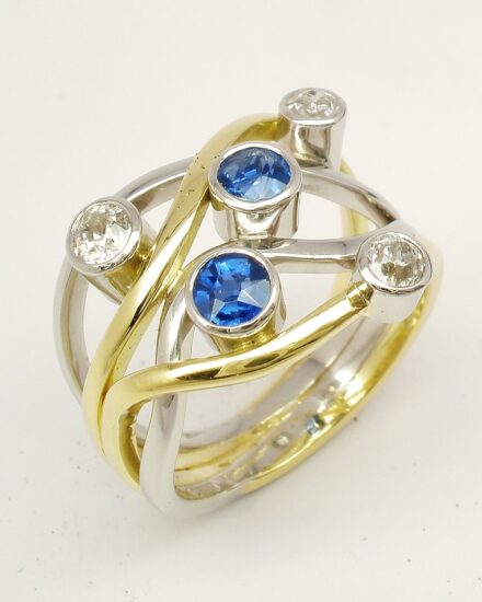 A 5 stone round sapphire and brilliant cut diamond 4 banded ring mounted in 18ct yellow gold and platinum.