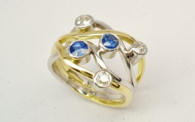 A 5 stone round sapphire and brilliant cut diamond 4 banded ring mounted in 18ct yellow gold and platinum.