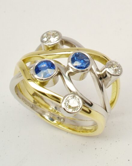 A 5 stone round sapphire and brilliant cut diamond 4 banded ring mounted in 18ct yellow gold and platinum.