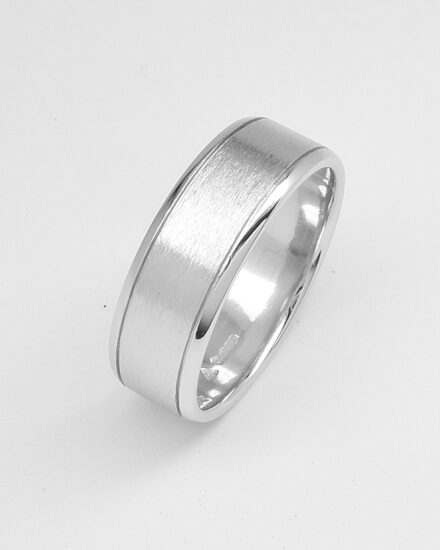 A gents 7mm broad platinum ring with lines cut 1.2mm i from both edges with polished edges and brushed finish centre.