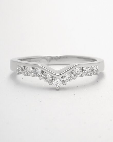 A 9 stone part channel set round brilliant cut diamond slight wishbone shaped ring shaped to fit with a 3 stone diamond ring mounted in platinum.