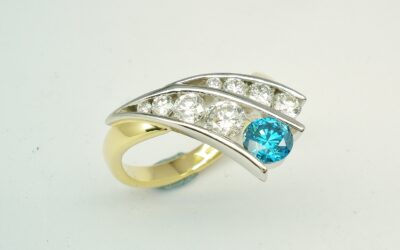 A 9 stone HTHP treated sky blue round brilliant cut diamond and white round brilliant cut diamond ring mounted in 18ct. yellow gold and platinum.
