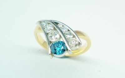 A 9 stone HTHP treated sky blue round brilliant cut diamond and white round brilliant cut diamond ring mounted in 18ct. yellow gold and platinum.