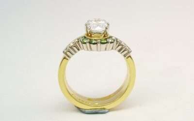 A 10 stone part channel set round brilliant cut green and white diamond wedding ring shaped to fit around a single stone oval diamond engagement ring.