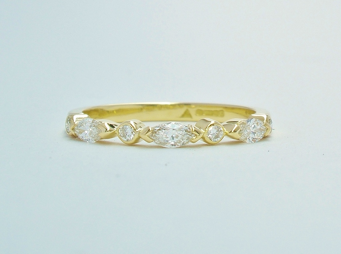 A 7 stone marquise cut and round brilliant cut diamond ring mounted in 18ct. yellow gold.