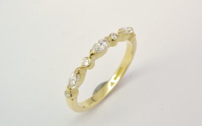 A 7 stone marquise cut and round brilliant cut diamond ring mounted in 18ct. yellow gold.
