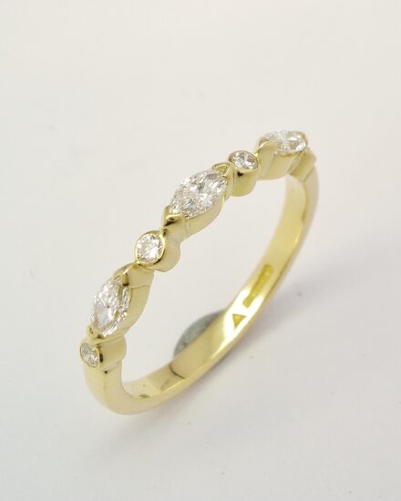 A 7 stone marquise cut and round brilliant cut diamond ring mounted in 18ct. yellow gold.