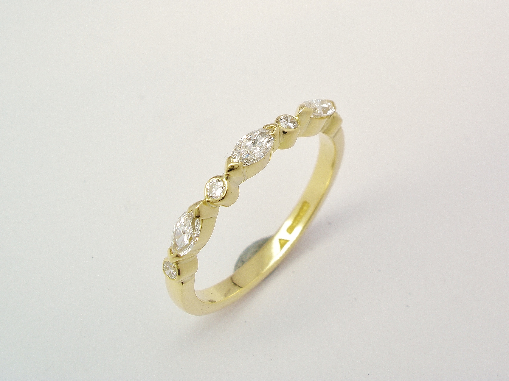 A 7 stone marquise cut and round brilliant cut diamond ring mounted in 18ct. yellow gold.