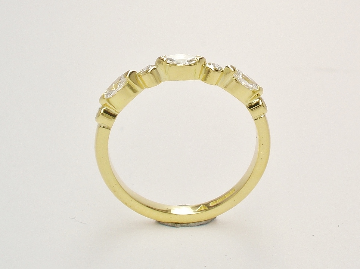 A 7 stone marquise cut and round brilliant cut diamond ring mounted in 18ct. yellow gold.
