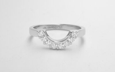 An 8 stone part channel set round brilliant cut diamond ring mounted in platinum and shaped to fir around a 13 stone round diamond cluster ring.
