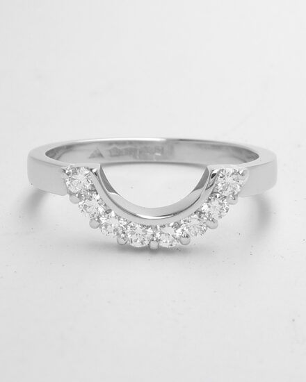 An 8 stone part channel set round brilliant cut diamond ring mounted in platinum and shaped to fir around a 13 stone round diamond cluster ring.