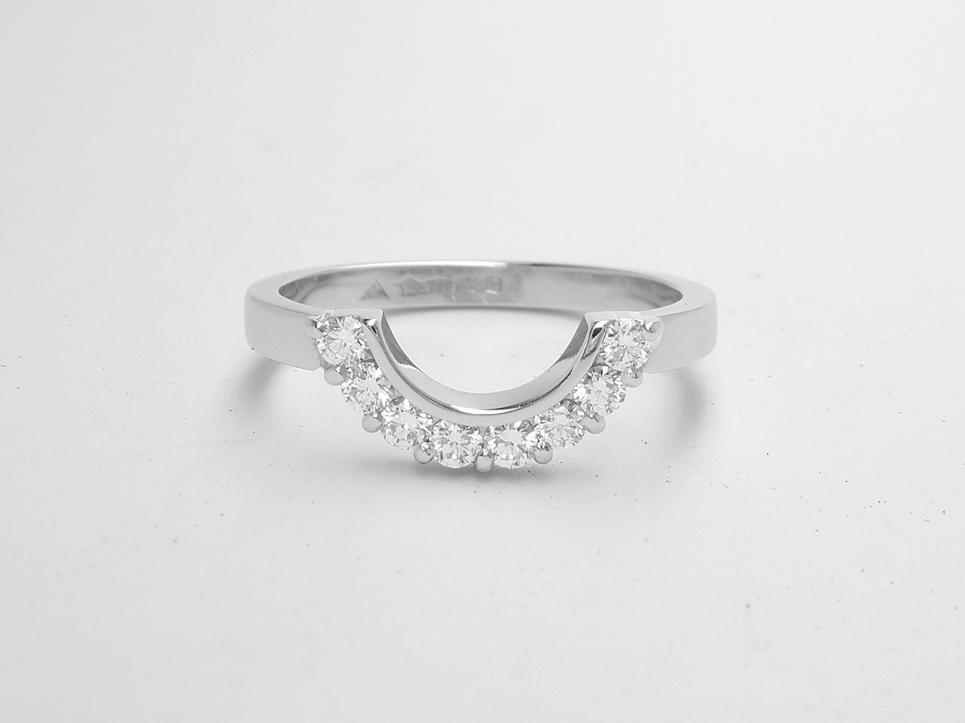 An 8 stone part channel set round brilliant cut diamond ring mounted in platinum and shaped to fir around a 13 stone round diamond cluster ring.