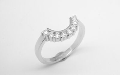 An 8 stone part channel set round brilliant cut diamond ring mounted in platinum and shaped to fir around a 13 stone round diamond cluster ring.