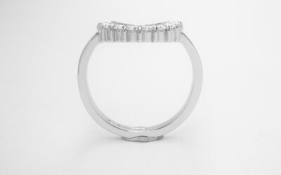 An 8 stone part channel set round brilliant cut diamond ring mounted in platinum and shaped to fir around a 13 stone round diamond cluster ring.