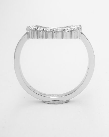 An 8 stone part channel set round brilliant cut diamond ring mounted in platinum and shaped to fir around a 13 stone round diamond cluster ring.
