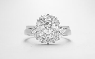 An 8 stone part channel set round brilliant cut diamond ring mounted in platinum and shaped to fir around a 13 stone round diamond cluster ring.