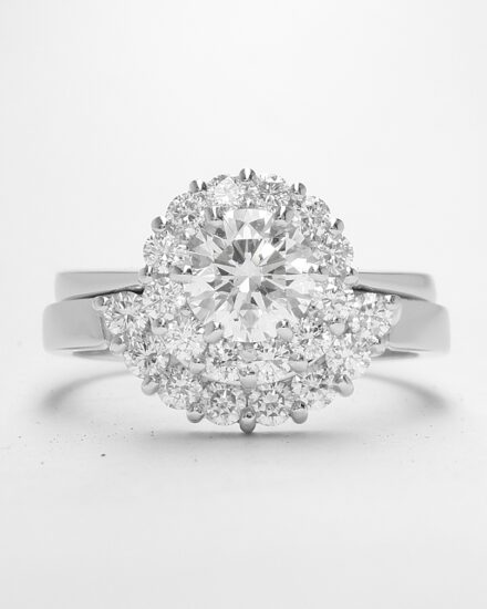 An 8 stone part channel set round brilliant cut diamond ring mounted in platinum and shaped to fir around a 13 stone round diamond cluster ring.