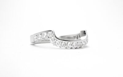 A 17 stone part channel set round brilliant cut diamond ring mounted in platinum & shaped to fit around a large 108 stone diamond cluster ring.