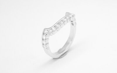 A 17 stone part channel set round brilliant cut diamond ring mounted in platinum & shaped to fit around a large 108 stone diamond cluster ring.