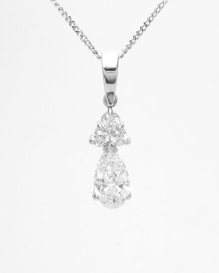 A 4 stone round brilliant cut and pear cut diamond pendant mounted in platinum