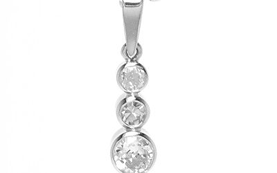 A 3 stone round brilliant cut diamond pendant mounted in platinum rub-over settings