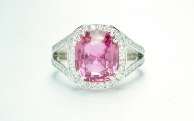 An 87 stone round brilliant cut diamond and rectangular cushion cut purple sapphire ring mounted in platinum.