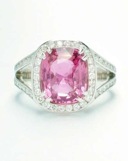An 87 stone round brilliant cut diamond and rectangular cushion cut purple sapphire ring mounted in platinum.