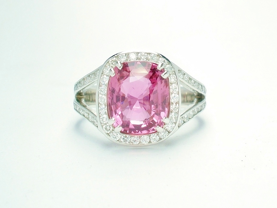 An 87 stone round brilliant cut diamond and rectangular cushion cut purple sapphire ring mounted in platinum.