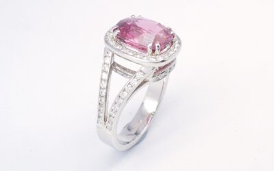 An 87 stone round brilliant cut diamond and rectangular cushion cut purple sapphire ring mounted in platinum.
