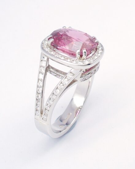An 87 stone round brilliant cut diamond and rectangular cushion cut purple sapphire ring mounted in platinum.