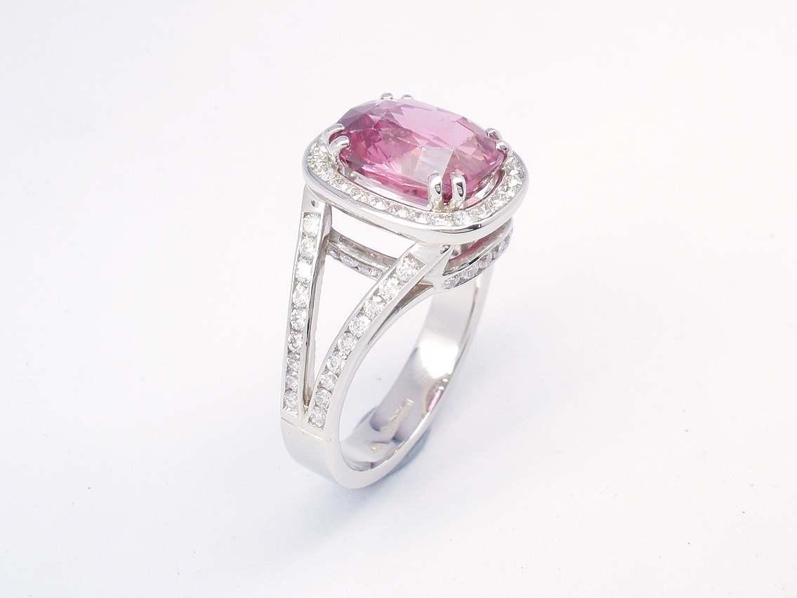 An 87 stone round brilliant cut diamond and rectangular cushion cut purple sapphire ring mounted in platinum.