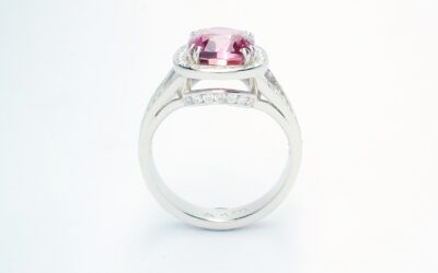 An 87 stone round brilliant cut diamond and rectangular cushion cut purple sapphire ring mounted in platinum.
