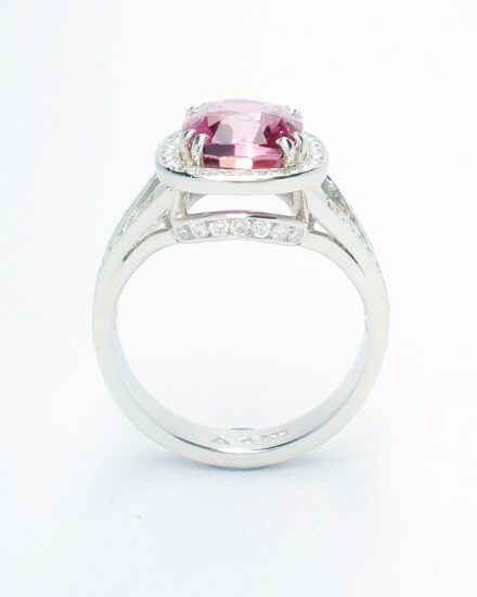 An 87 stone round brilliant cut diamond and rectangular cushion cut purple sapphire ring mounted in platinum.