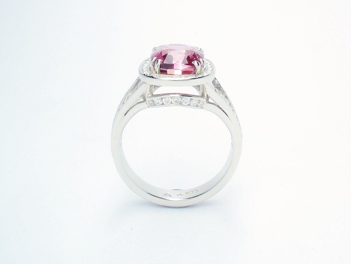 An 87 stone round brilliant cut diamond and rectangular cushion cut purple sapphire ring mounted in platinum.