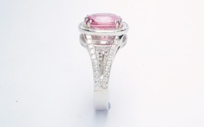 An 87 stone round brilliant cut diamond and rectangular cushion cut purple sapphire ring mounted in platinum.