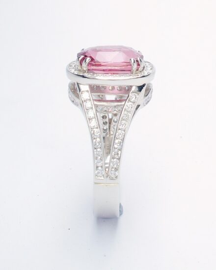 An 87 stone round brilliant cut diamond and rectangular cushion cut purple sapphire ring mounted in platinum.