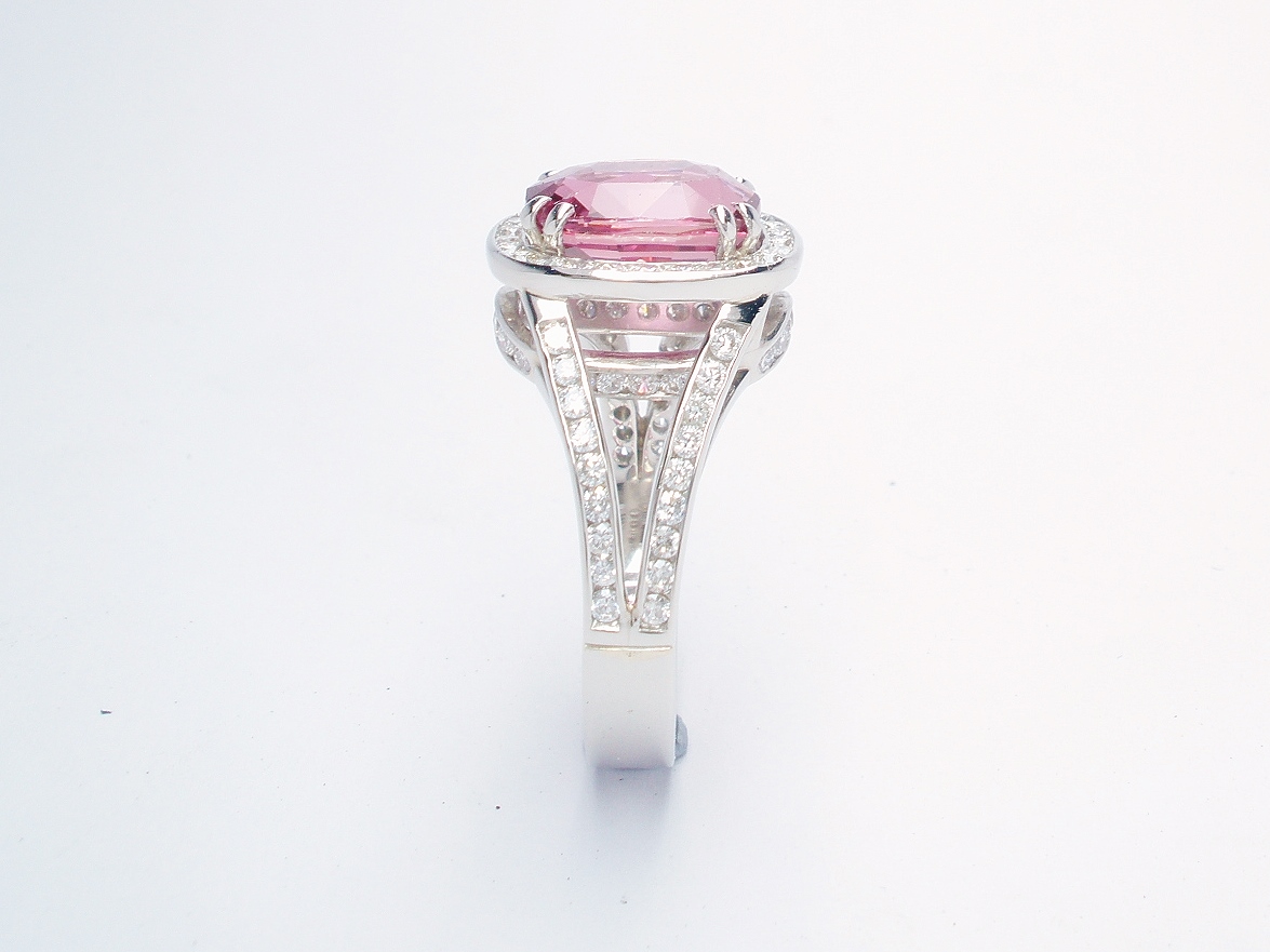 An 87 stone round brilliant cut diamond and rectangular cushion cut purple sapphire ring mounted in platinum.