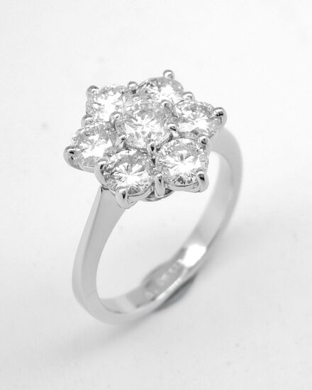 A 7 stone round brilliant cut diamond cluster set in platinum.