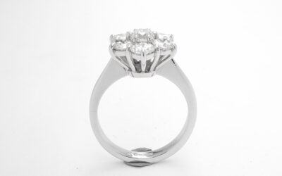 A 7 stone round brilliant cut diamond cluster set in platinum.