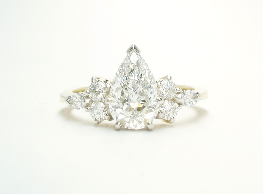 A 7 stone pear shaped, brilliant cut and marquise cut Lab grown diamond ring mounted in 18ct yellow gold and platinum.