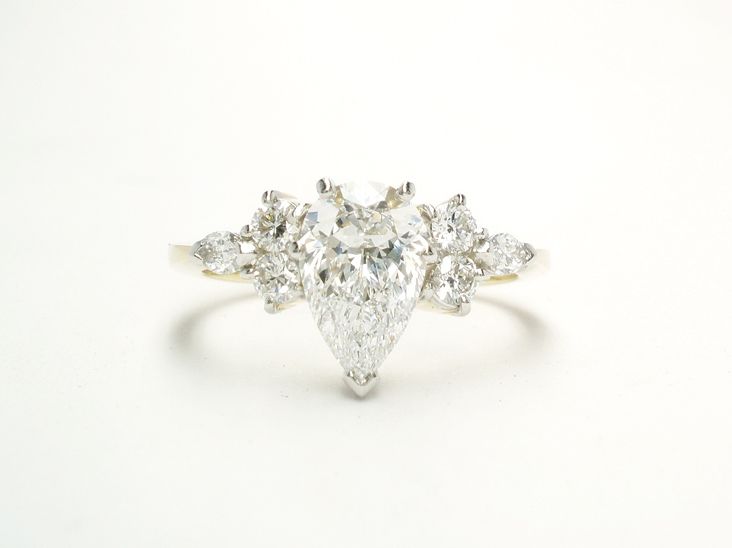 A 7 stone pear shaped, brilliant cut and marquise cut Lab grown diamond ring mounted in 18ct yellow gold and platinum.