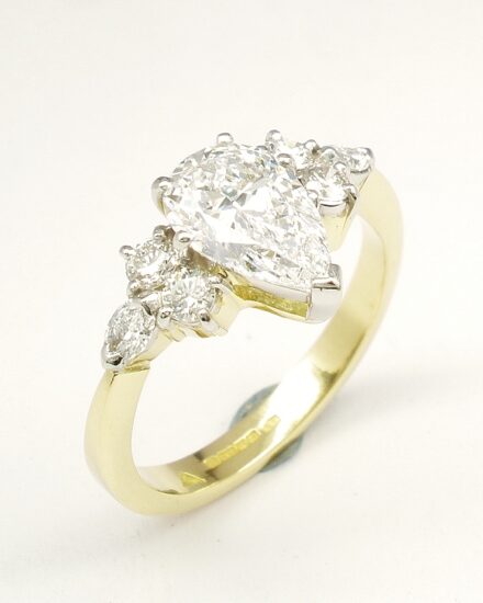 A 7 stone pear shaped, brilliant cut and marquise cut Lab grown diamond ring mounted in 18ct yellow gold and platinum.