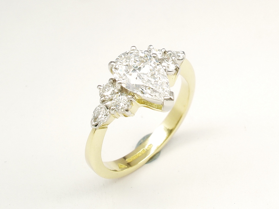 A 7 stone pear shaped, brilliant cut and marquise cut Lab grown diamond ring mounted in 18ct yellow gold and platinum.