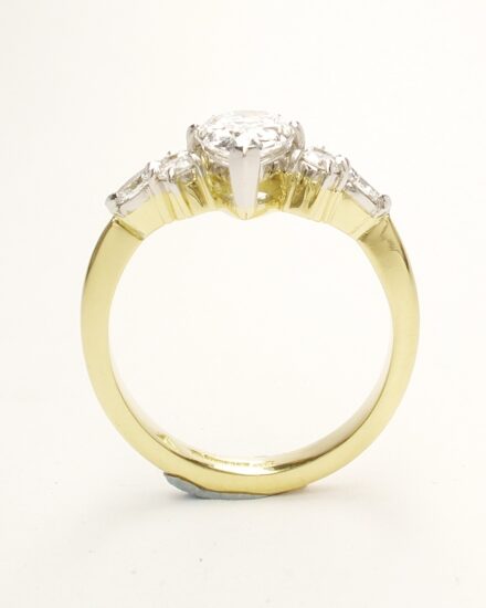 A 7 stone pear shaped, brilliant cut and marquise cut Lab grown diamond ring mounted in 18ct yellow gold and platinum.