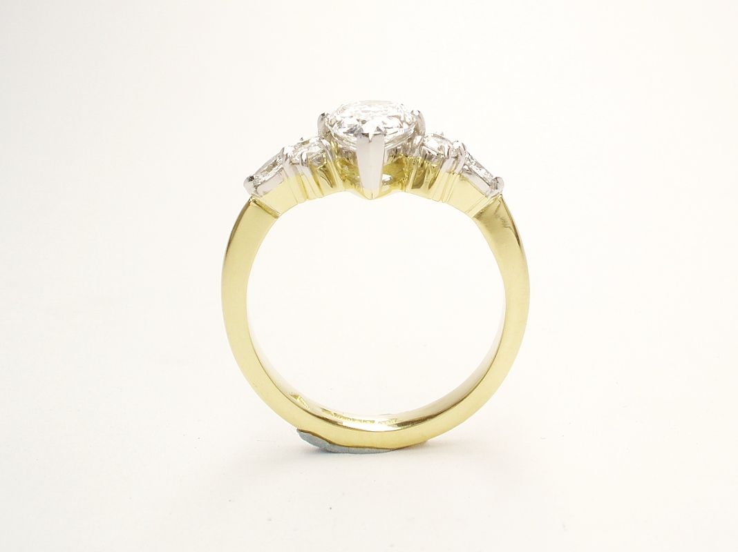 A 7 stone pear shaped, brilliant cut and marquise cut Lab grown diamond ring mounted in 18ct yellow gold and platinum.