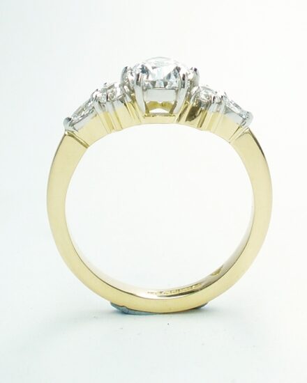 A 7 stone pear shaped, brilliant cut and marquise cut Lab grown diamond ring mounted in 18ct yellow gold and platinum.